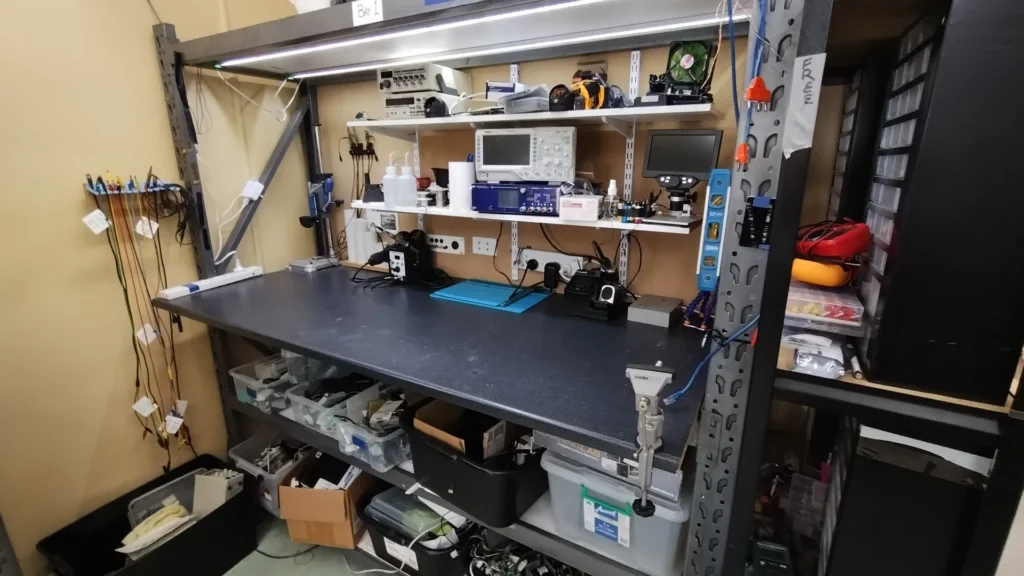 Electronics workbench bay with test equipment, tools and parts storage in the Workshop