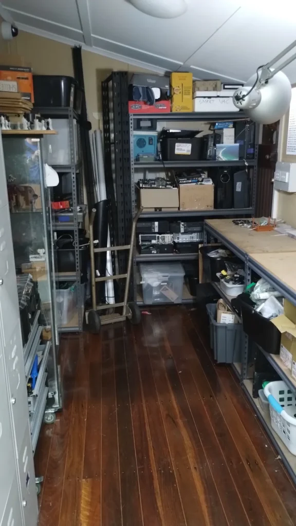 Storage room shelves stacked with parts, components and salvaged electronics