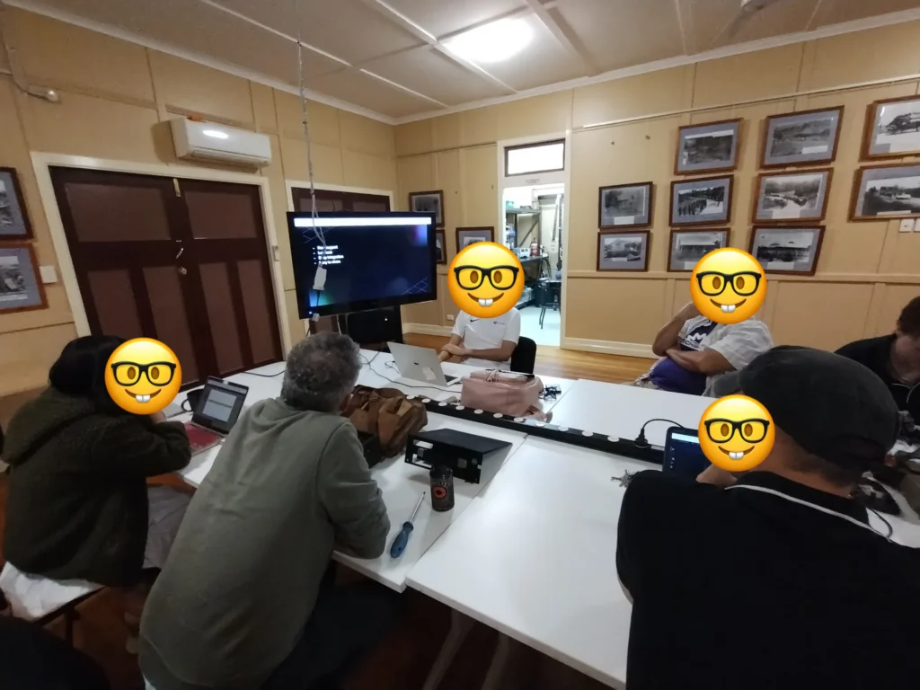Members working on laptops around tables during a meetup night in the Main Hall