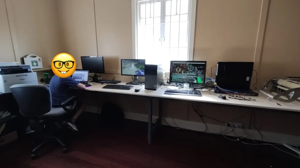 Computer lab in the Quiet Room with desktop PCs along a long desk