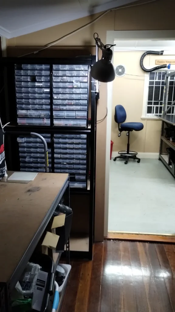 Parts drawers and workbench in the storage room looking through to the Quiet Room